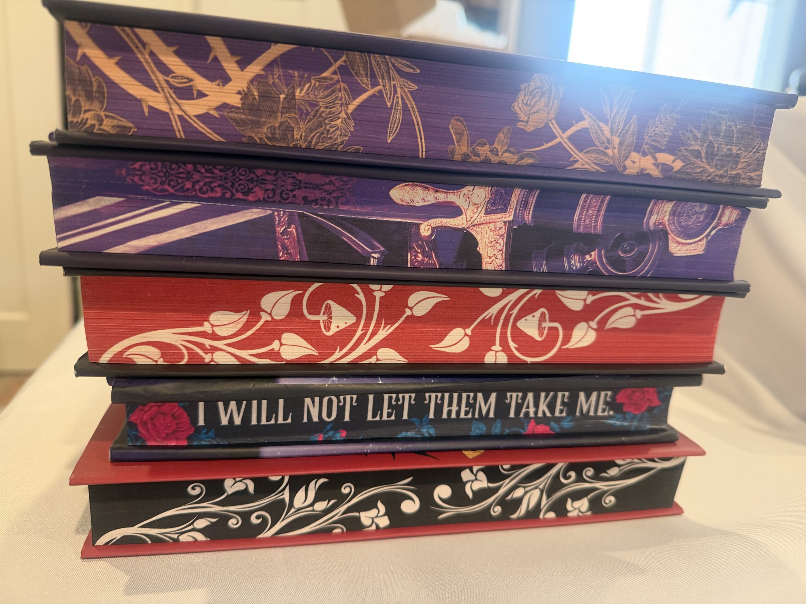 Stack of books with colorful decorated page edges