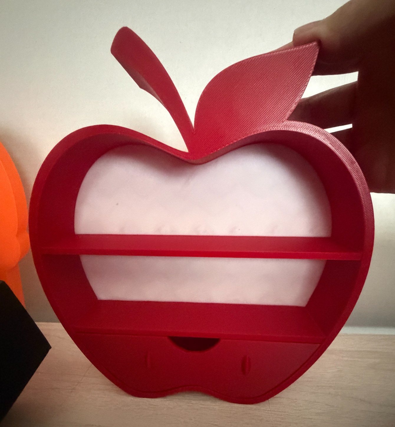 Red apple-shaped miniature bookshelf with a drawer