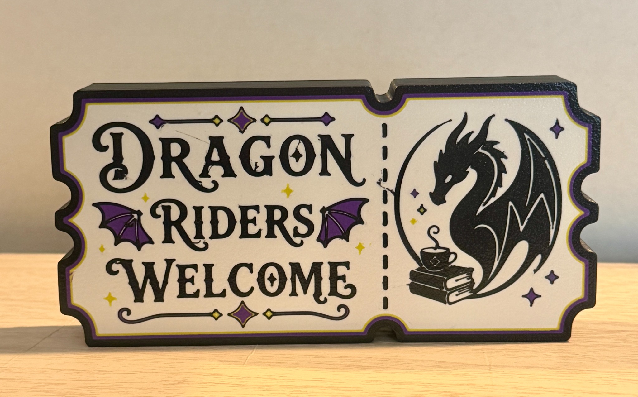 Cream and purple Dragon Riders Welcome shelf sign